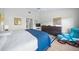 Spacious main bedroom with king-size bed, dresser, and a blue accent chair at 4573 Pine Green Trl # 1, Sarasota, FL 34241
