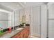 Well-lit bathroom with granite countertops, a single sink vanity, and tiled shower at 467 Canal Rd # 467, Sarasota, FL 34242