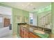 Modern bathroom with double vanity and a view into the bedroom at 467 Canal Rd # 467, Sarasota, FL 34242