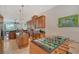 Spacious kitchen with wooden cabinets, stainless steel appliances, and a foosball table, offering style and entertainment at 467 Canal Rd # 467, Sarasota, FL 34242