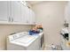 Bright laundry room with white cabinets, washer, and dryer at 467 Canal Rd # 467, Sarasota, FL 34242
