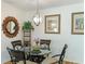 Bright dining area with glass table and four chairs, complemented by decorative wall art at 4817 Sarasota Ave, Sarasota, FL 34234
