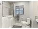 Accessible bathroom with a walk-in tub, gray tile accents, and a comfort height toilet and grab bar at 4817 Sarasota Ave, Sarasota, FL 34234