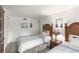 Bright bedroom features two twin beds, white linens, and woven headboards for a calming and cozy atmosphere at 4817 Sarasota Ave, Sarasota, FL 34234