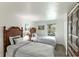 Inviting bedroom with twin beds, woven headboards, and natural light creates a serene and relaxing space at 4817 Sarasota Ave, Sarasota, FL 34234