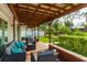 Covered patio features a pergola, comfortable seating, and a dining table at 4817 Sarasota Ave, Sarasota, FL 34234