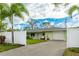 Light green house with a white fence and palm trees at 4817 Sarasota Ave, Sarasota, FL 34234