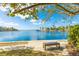 Beautiful waterfront view featuring a seating area by the water with tropical foliage at 4817 Sarasota Ave, Sarasota, FL 34234