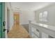 Bright foyer with tile flooring, a view into the living room, and a half wall at 7819 Ashley Cir, Bradenton, FL 34201