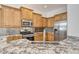 Kitchen with granite countertops, stainless steel appliances, and light wood cabinets at 7819 Ashley Cir, Bradenton, FL 34201