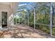 Bright screened-in porch with a view of the backyard and trees at 7819 Ashley Cir, Bradenton, FL 34201