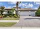 Two-story house with a three-car garage and landscaped front yard at 7833 Valderrama Way, Lakewood Ranch, FL 34202