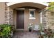 Inviting front porch with stone columns and seating at 8418 Nandina Dr, Sarasota, FL 34240