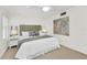 Bedroom with king-size bed and large art piece at 1048 W Peppertree Ln # 118B, Sarasota, FL 34242