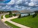 Side view of single story home with gray tile roof, landscaping and two car garage at 12715 Coastal Breeze Way, Bradenton, FL 34211