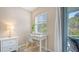 Home office with white desk and chair, near sliding glass door at 1328 Siesta Bayside Dr # 1328-C, Sarasota, FL 34242