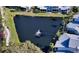 Arial view of a tranquil pond with fountain in a lush tropical setting at 1328 Siesta Bayside Dr # 1328-C, Sarasota, FL 34242