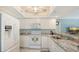 Bright kitchen with granite counters and view to living room at 1328 Siesta Bayside Dr # 1328-C, Sarasota, FL 34242