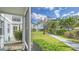 Screened porch view of backyard, walkway, and neighboring building at 1328 Siesta Bayside Dr # 1328-C, Sarasota, FL 34242