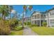 Paved walkway winds through lush landscaping, showcasing the community's serene environment at 1328 Siesta Bayside Dr # 1328-C, Sarasota, FL 34242