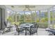 Screened porch with table and chairs, overlooking a lush landscape at 1328 Siesta Bayside Dr # 1328-C, Sarasota, FL 34242
