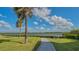 Peaceful waterfront walkway with a bench overlooking the calm waters at 1328 Siesta Bayside Dr # 1328-C, Sarasota, FL 34242
