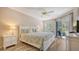 Main bedroom with king-size bed, dresser, and access to the porch at 1328 Siesta Bayside Dr # 1328-C, Sarasota, FL 34242