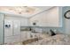 White kitchen with granite countertops and appliances at 1328 Siesta Bayside Dr # 1328-C, Sarasota, FL 34242