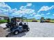 Golf carts parked near clubhouse, lush landscaping, and blue sky at 15625 San Lazzaro Ave, Bradenton, FL 34211
