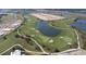 Aerial view of golf course community with lake and homes at 15625 San Lazzaro Ave, Bradenton, FL 34211