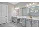 Elegant bathroom boasting double sinks, gray cabinets, and a large mirror at 15625 San Lazzaro Ave, Bradenton, FL 34211