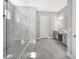 Modern bathroom with gray cabinets, a large shower, and a double vanity at 15625 San Lazzaro Ave, Bradenton, FL 34211
