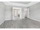 Light-filled bedroom with wood-look floors and access to bathroom and additional rooms at 15625 San Lazzaro Ave, Bradenton, FL 34211