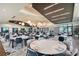 Spacious clubhouse dining hall displaying multiple tables, stylish chairs, pendant lighting, and scenic outdoor views at 15625 San Lazzaro Ave, Bradenton, FL 34211