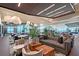 Expansive clubhouse lounge featuring stylish furniture, wood accent tables, overhead lighting, and large windows with views at 15625 San Lazzaro Ave, Bradenton, FL 34211