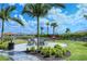 Relaxing community seating area with fire pit, landscaping, and palm trees at 15625 San Lazzaro Ave, Bradenton, FL 34211