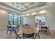 Inviting dining area with community tables, large windows showcasing palm tree views, and a sliding barn door at 15625 San Lazzaro Ave, Bradenton, FL 34211
