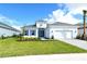 Single-story home with gray roof, blue shutters, and landscaped yard at 15625 San Lazzaro Ave, Bradenton, FL 34211