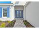 Double blue front doors with glass inserts and a stone walkway at 15625 San Lazzaro Ave, Bradenton, FL 34211