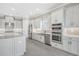 Spacious kitchen with island, stainless steel appliances, and white cabinets at 15625 San Lazzaro Ave, Bradenton, FL 34211
