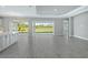 Open floor plan living room with tile floors and view to backyard at 15625 San Lazzaro Ave, Bradenton, FL 34211