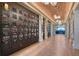 Beautiful wine room with individual wine lockers, herringbone floors, and elegant lighting at 15625 San Lazzaro Ave, Bradenton, FL 34211
