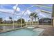 Enclosed pool and spa with a view of the lake and other homes at 16381 Cape Horn Blvd, Punta Gorda, FL 33955