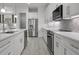 Modern kitchen featuring white cabinetry, stainless steel appliances, and herringbone backsplash at 16381 Cape Horn Blvd, Punta Gorda, FL 33955