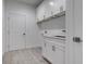 Laundry room with white cabinets and countertop at 16381 Cape Horn Blvd, Punta Gorda, FL 33955