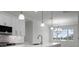 Kitchen with white cabinets, quartz countertops, and a view to the backyard at 16381 Cape Horn Blvd, Punta Gorda, FL 33955