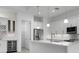 White kitchen with an island, stainless steel appliances, and a wine cooler at 16381 Cape Horn Blvd, Punta Gorda, FL 33955