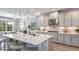 Modern kitchen with large island, stainless steel appliances, and white cabinets at 16431 Star Grass Cir, Bradenton, FL 34211