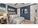 Bedroom with a double bed, a window, and a dark blue accent wall at 16431 Star Grass Cir, Bradenton, FL 34211