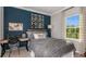 Bedroom with a full-size bed, desk, and window at 16431 Star Grass Cir, Bradenton, FL 34211